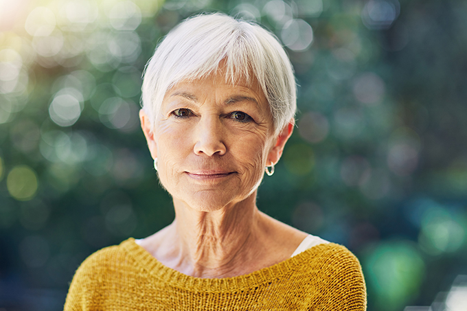 Close up portrait of elderly lady looking pensively at the camera