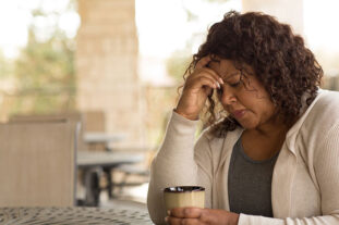 Woman sitting, thinking and looking concerned and pensive