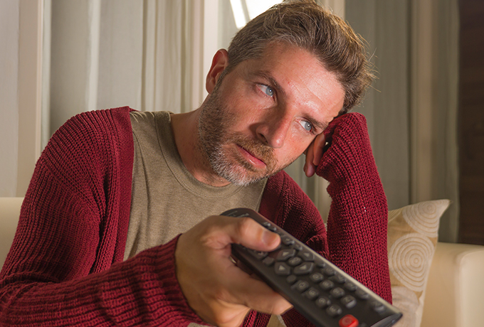 Man anxious and stressed watching tv