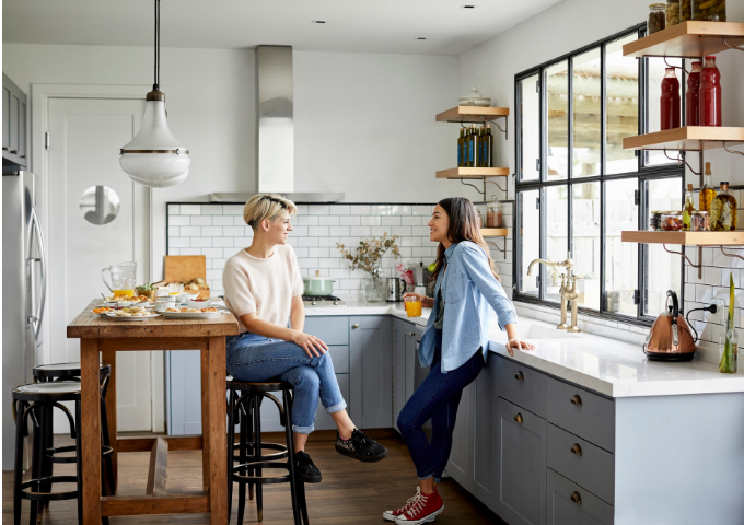 Couple standing in kitchen talking