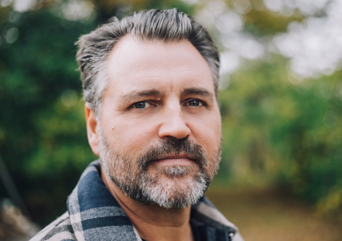 Close up portrait of male looking pensively at camera