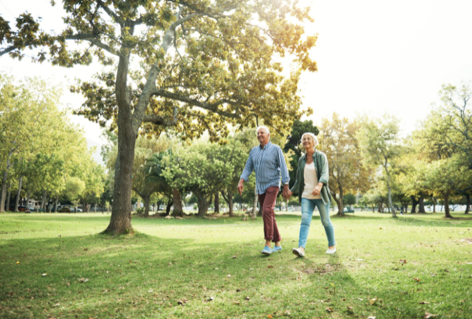 Older couple walking in a park