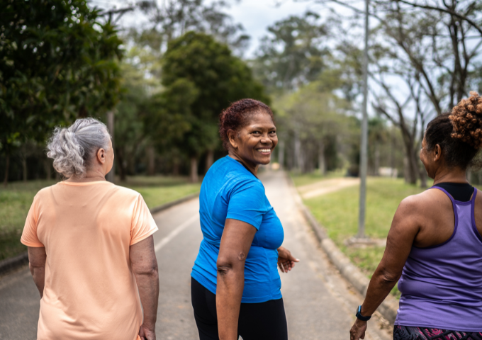 Three women walking outside looking content
